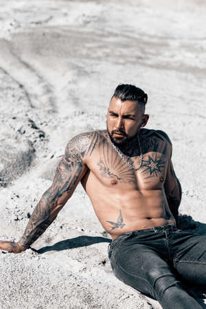 Sexy portrait of handsome muscular topless male model at the beach.の写真素材