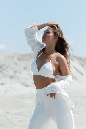 Charming woman standing on beachの写真素材