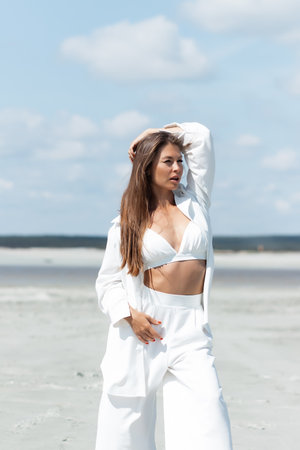 Beautiful woman standing on seashoreの写真素材