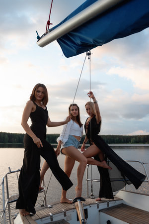 Young women on yacht at sunsetの写真素材