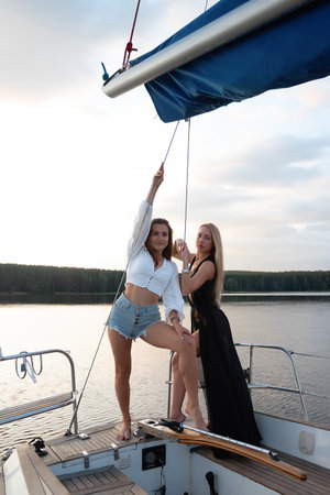 Young women on yacht at sunsetの写真素材