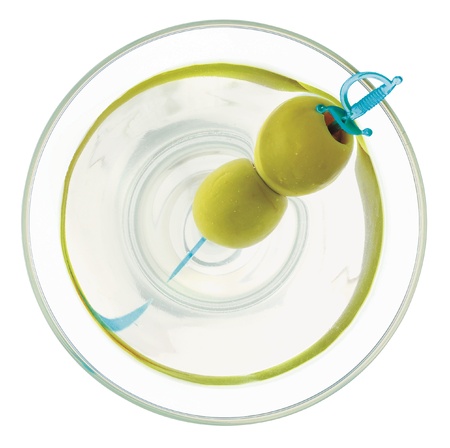 A martini with two olives skewered on a blue plastic sword viewed from directly overhead. Isolated on white の写真素材