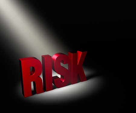 Angled spotlight revealing red "Risk" on a dark background.の写真素材