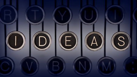 Close up of old typewriter keyboard with scratched chrome keys that spell out  IDEAS   Lighting and focus are centered on  IDEAS   の写真素材