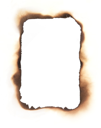 The charred  edges of a burned through rectangular hole isolated on white  Use as a frame or composite with any sheet of paper to create a burned through area in the paper の写真素材