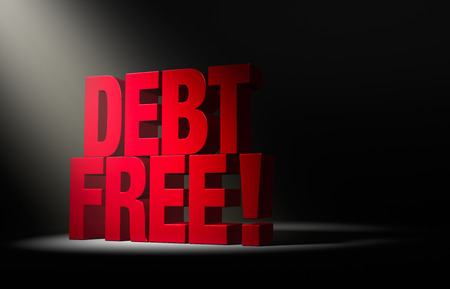 Angled spotlight reveals a bold, red DEBT FREE on a dark .の写真素材