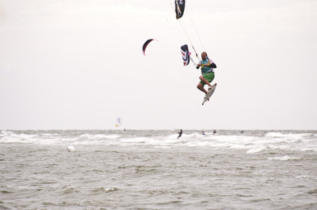 ST. PETER-ORDING, GERMANY - JULY 22: Professional  kite-surfer Dennis Leuthold, Germany,  demonstrating his ability on the Palmolive Kitesurf Worldcup 2010 in St. Peter-Ording, July 22, 2010 in St. Peter-Ording, Germanyのeditorial素材