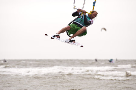 ST. PETER-ORDING, GERMANY - JULY 22: Professional  kite-surfer Dennis Leuthold, Germany,  demonstrating his ability on the Palmolive Kitesurf Worldcup 2010 in St. Peter-Ording, July 22, 2010 in St. Peter-Ording, Germanyのeditorial素材