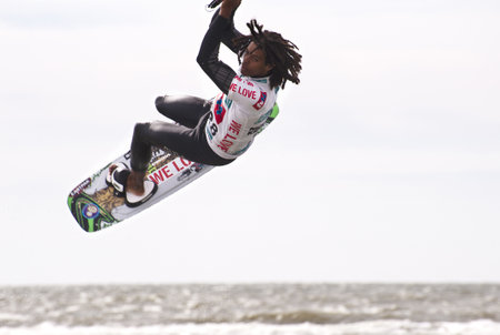 ST. PETER-ORDING, GERMANY - JULY 22: Professional  kite-surfer Emmanuel Norman, Germany,  demonstrating his ability on the Palmolive Kitesurf Worldcup 2010 in St. Peter-Ording, July 22, 2010 in St. Peter-Ording, Germanyのeditorial素材