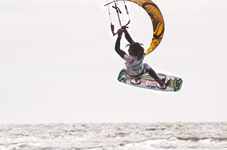 ST. PETER-ORDING, GERMANY - JULY 22: Professional  kite-surfer Emmanuel Norman, Germany,  demonstrating his ability on the Palmolive Kitesurf Worldcup 2010 in St. Peter-Ording, July 22, 2010 in St. Peter-Ording, Germanyのeditorial素材