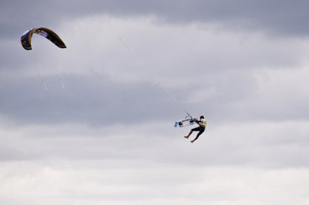ST. PETER-ORDING, GERMANY - JULY 24: Professional kite-surfer demonstrating his ability on the Palmolive Kitesurf Worldcup 2010 in St. Peter-Ording, July 24, 2010 in St. Peter-Ording, Germanyのeditorial素材