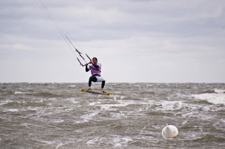 ST. PETER-ORDING, GERMANY - JULY 24: Professional kite-surfer demonstrating his ability on the...