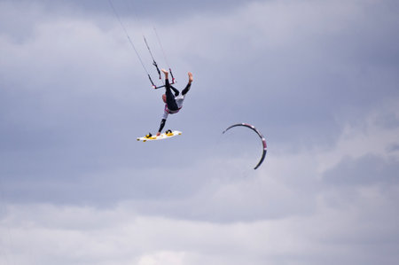 ST. PETER-ORDING, GERMANY - JULY 24: Professional kite-surfer demonstrating his ability on the Palmolive Kitesurf Worldcup 2010 in St. Peter-Ording, July 24, 2010 in St. Peter-Ording, Germanyのeditorial素材