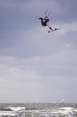 ST. PETER-ORDING, GERMANY - JULY 24: Professional kite-surfer demonstrating his ability on the Palmolive Kitesurf Worldcup 2010 in St. Peter-Ording, July 24, 2010 in St. Peter-Ording, Germanyのeditorial素材