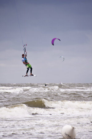 ST. PETER-ORDING, GERMANY - JULY 24: Professional kite-surfer demonstrating his ability on the Palmolive Kitesurf Worldcup 2010 in St. Peter-Ording, July 24, 2010 in St. Peter-Ording, Germanyのeditorial素材
