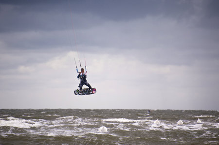 ST. PETER-ORDING, GERMANY - JULY 24: Professional kite-surfer demonstrating his ability on the Palmolive Kitesurf Worldcup 2010 in St. Peter-Ording, July 24, 2010 in St. Peter-Ording, Germanyのeditorial素材