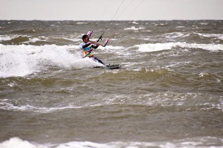 ST. PETER-ORDING, GERMANY - JULY 24: Professional kite-surfer Gunnar Biniasch, Germany, demonstrating his ability on the Palmolive Kitesurf Worldcup 2010 in St. Peter-Ording, July 24, 2010 in St. Peter-Ording, Germanyのeditorial素材