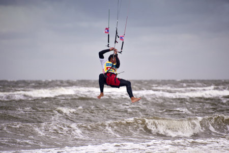 ST. PETER-ORDING, GERMANY - JULY 24: Professional kite-surfer Gunnar Biniasch, Germany, demonstrating his ability on the Palmolive Kitesurf Worldcup 2010 in St. Peter-Ording, July 24, 2010 in St. Peter-Ording, Germanyのeditorial素材
