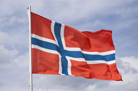 Waving norwegian Flag with cloudy Skyの写真素材