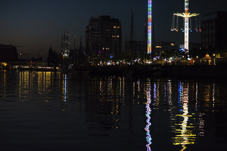 Reflective Night Lights on a Water Surface on the Kiel Week Festival in Germany