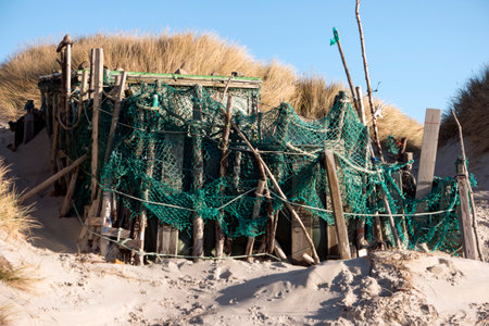 AMRUM, GERMANY - JANUARY 02, 2018: On the Kniepsand Beach of  the North Frisian Island Amrum in Germany Land-Artists made Beach Huts and other Objects out of Flotsam and Jetsamのeditorial素材