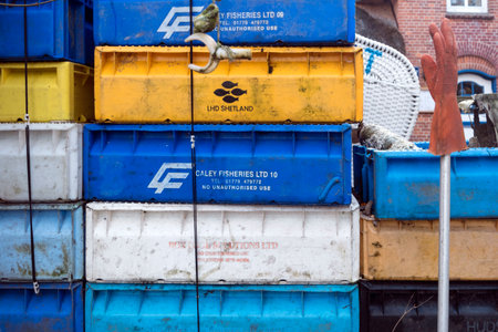 AMRUM, GERMANY - JANUARY 02, 2018: Fishing crates, buoys and other maritime objects in front of the...