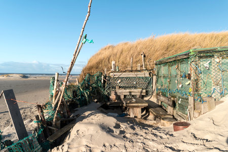 AMRUM, GERMANY - JANUARY 02, 2018: On the Kniepsand Beach of  the North Frisian Island Amrum in Germany Land-Artists made Beach Huts and other Objects out of Flotsam and Jetsamのeditorial素材