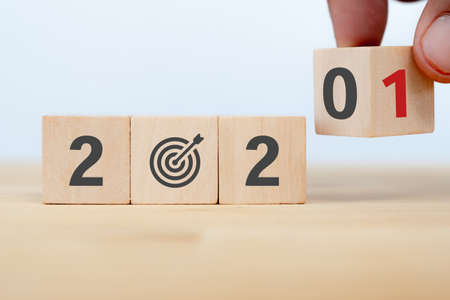 2021 strategy business growth concept. businessman hand flip wooden cubes from new year 2020 to 2021の写真素材