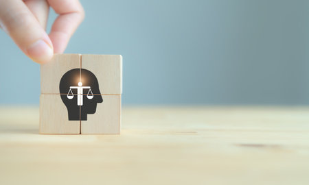 Business ethics concept. Ethics inside human mind. Business integrity and moral. The wooden cubes with ethics inside a head symbols on grey background and copy space. Company ethics culture. ESG.の写真素材