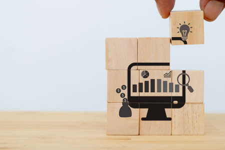 Data driven marketing concept.  Analysis market strategy,personalized and contextual marketing. Marketing technology.  Man puts the wooden cubes with data driven icon on white background and copy spaceの写真素材