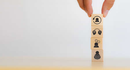 New skill development for business adaptation of technology and digital transformation. Changing skill demand. Hand hold wood cubes re-skill icon with self learning, coaching, knowledge sharing icon.の写真素材