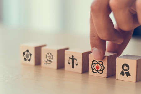 Core values,corporate values concept.  Company culture and strategy related to business, customer, people, company growth. Principles guide company's action. Core values icon on flat wood cube. Bannerの写真素材