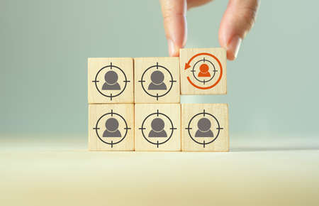 Digital marketing, retargeting or remarketing concept. Online strategies in social media, website visitor management and solution for marketing campaigns. Puttiing wooden cubes with retargeting icon.の写真素材