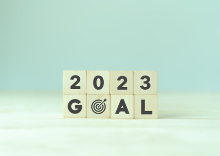 2023 goals of business or life. Wooden cubes with 2023 and goal icon on smart background. Starting...