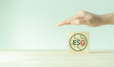 ESG and sustainable development concept. Positive impact for environment, social and governance. Socially responsible investing, ESG factors. Hand protection the earth with ESG strategy solution.の写真素材
