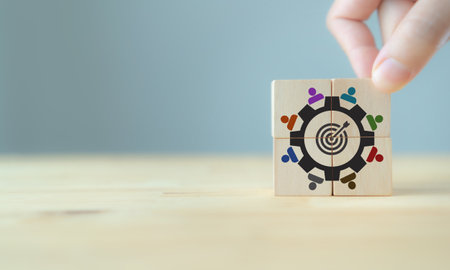 Team building and diversity and common goal concept. Work collaboration for achieving goal and successful business. Productive people skills. Placing wooden cubes with team diversity building icons.の写真素材