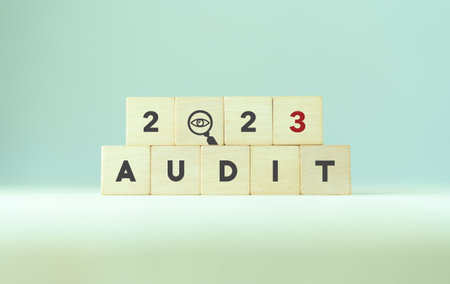 2023 annual audit business concept. Examination, evaluation financial statements; income statement, balance sheet, cash flow statement.  Wooden cubes with audit in 2023 icon.の写真素材