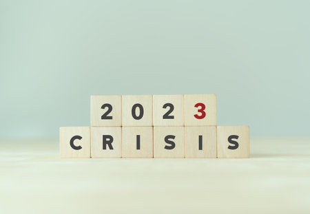 Crisis management concept in new year 2023 . Unexpected situation effects to business and life.  Wooden cubes 2023 with text "CRISIS" on beautiful grey background and copy space.の写真素材