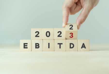 EBITDA in 2023 - Earnings Before Interest, Taxes, Depreciation and Amortization. Business, financial, money investment profit concept on wooden cubes. Bussiness goals, plan and achievement in 2023.の写真素材