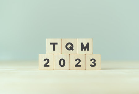 2023 TQM planning, Total quality management concept. Management approach to long-term success through customer satisfaction and sustainability. Wooden cubes with TQM 2023 on smart background.の写真素材