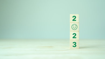 Happy new year 2023.  Starting to new year. 2023 written on wooden cubes with smart background. 
Happy people for better of living. Green community. Goals, plan, opportunity and new business or life.の写真素材