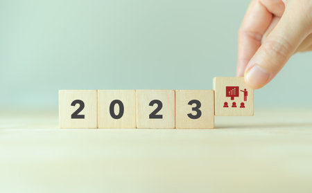 Training and knowledge sharing concept. Workforce and team training plan in 2023.  Wooden cubes with 2023 and training symbols on smart background and copy space. Training program planning by HRM.の写真素材