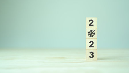 2023 goals of business or life. Wooden cubes with 2023 and goal icon on smart background. Starting to new year. Business common goals for planning new project, annual plan, business target achievementの写真素材