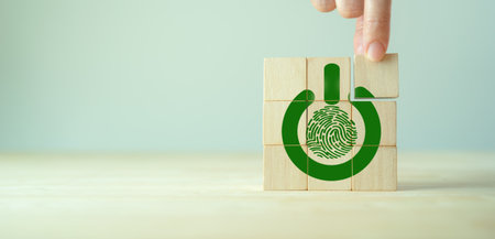 ECO solutions, Climate action concept. Actions to protect, better manage and restore nature to reduce greenhouse gas emissions. Green power button and fingerprint on wooden cube block and copy space.の写真素材