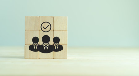 HR compliance, employee regulation and compliance, business ethics, employee performance evaluation concept. Wooden cube blocks with check mark and employees icons on clean background and copy space.の写真素材