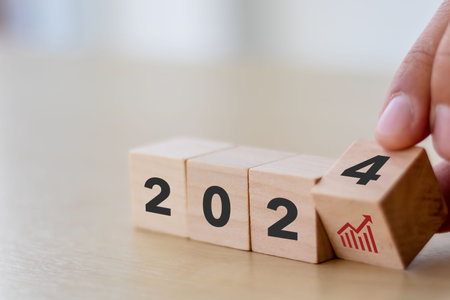Business growth concept in 2024. Business goals and achievement. Wooden cubes inscripted 2024 and growth icon on smart background. Positive indicators banner.の写真素材