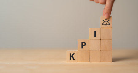KPI concept. Employee proformance. Key Performance Indicator using business intelligence metrics to measure achievement versus planned target. "KPI" abbreviation and meter  icons on wood blocks.の写真素材