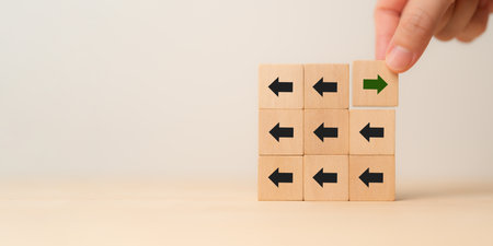 New ways of working, differentiation strategy concept  symbol on wood blocks. Providing uniqueness, different and distinct from competitors, creating competitive advantage. Business direction concept.の写真素材