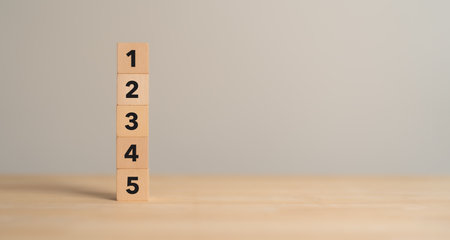 Task priority and management concept. The order of priority in any activity. Set work priority, arrange to do list. Wooden cube blocks with number first, second, third, fourth and fifth.の写真素材