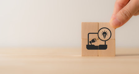 Creative marketing concept. Leveraging technology, data analysis, and customer insights to create innovative campaigns that engage audiences,drive ROI. Wooden cube block with creative marketing icons.の写真素材